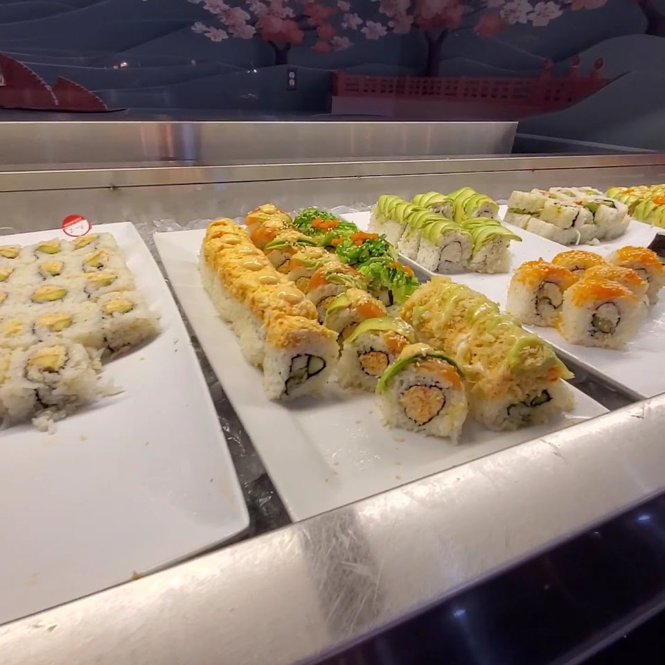 Dessert counter with colorful sweets behind glass.